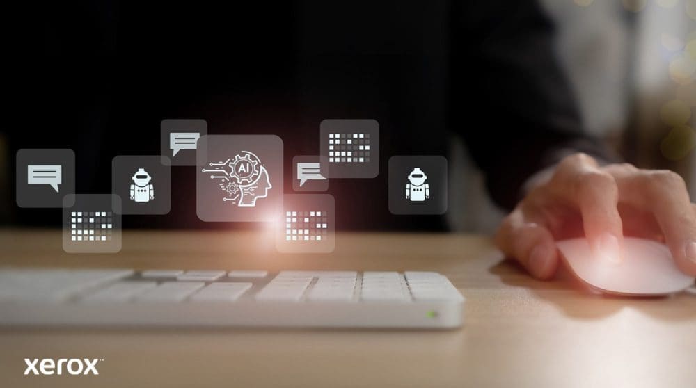 Xerox® DocuShare® Go: Intelligentes Dokumentenmanagement Die Hand einer Person liegt auf einer Computermaus, über der Tastatur schweben abstrakte leuchtende Symbole aus den Bereichen Kommunikation, KI und Datenverarbeitung, die intelligente Dokumentfunktionen darstellen.